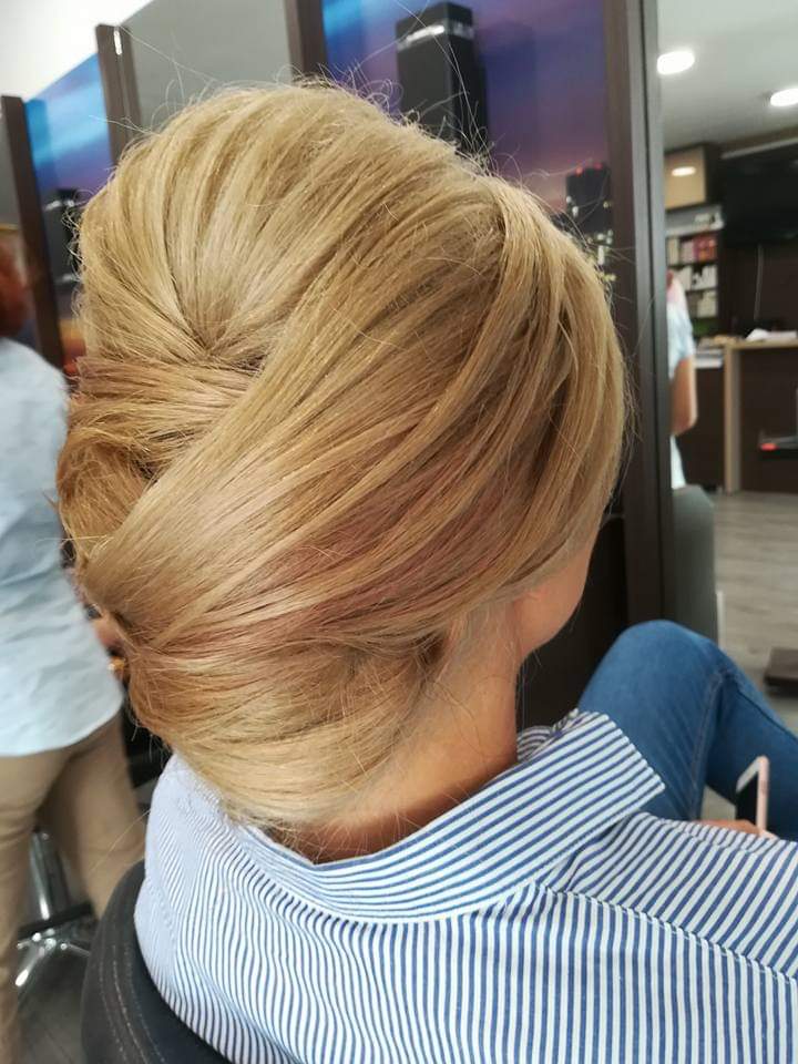 Formal updo — elegant French twist on warm golden blonde hair, back view at Divine Retreat salon