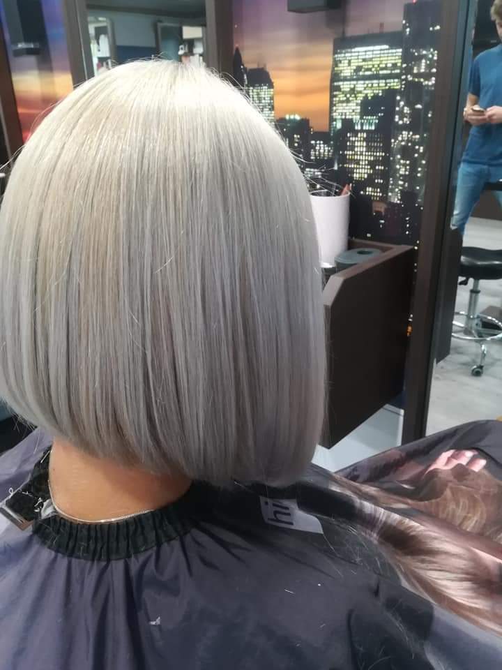 Precision bob cut — sleek silver-grey graduated bob on straight hair, back view at Divine Retreat salon