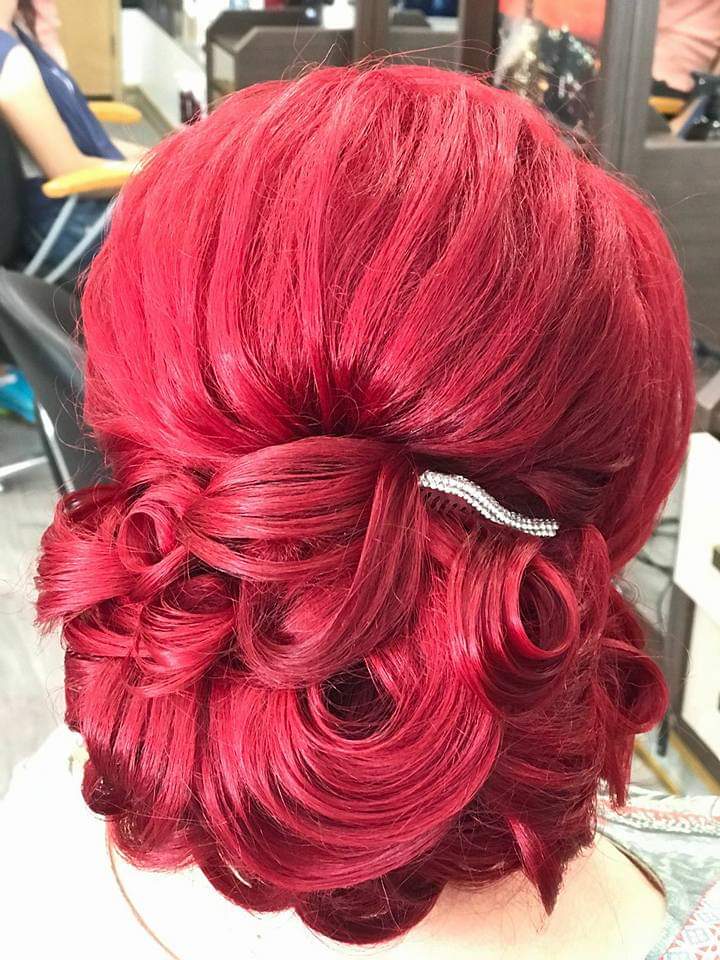 Formal updo — vintage-inspired curled low bun on vivid red hair with crystal hairpin accent, back view at Divine Retreat salon