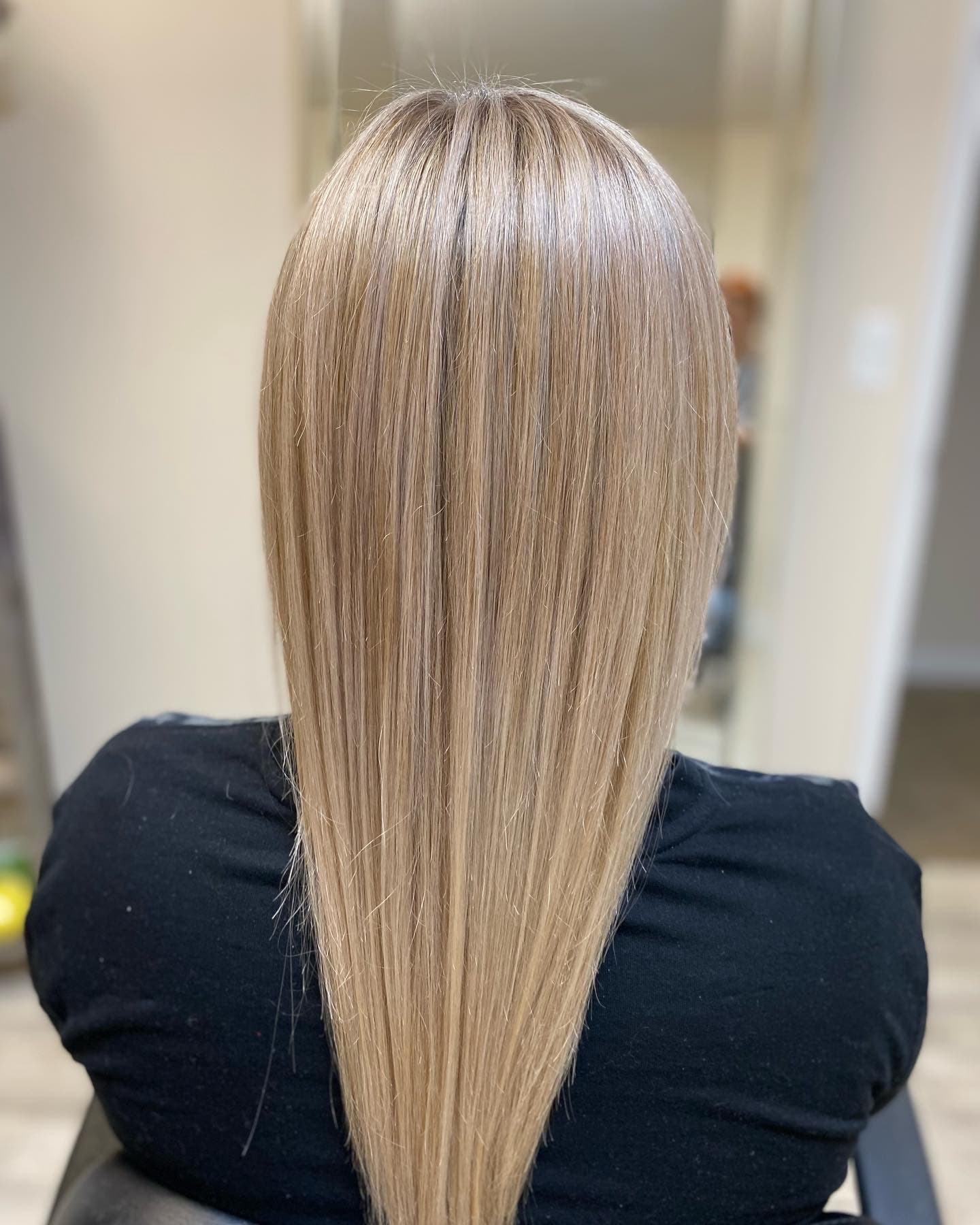 Balayage — natural dark blonde root blending into soft sandy blonde on long straight hair with a V-shaped cut, back view at Divine Retreat salon